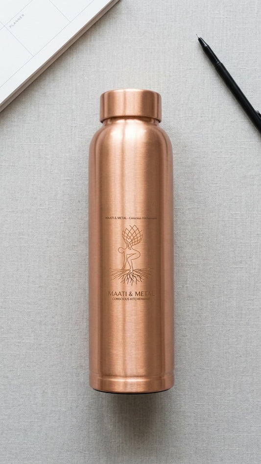 Pure Copper Bottle 1 Litre — flat lay with planner